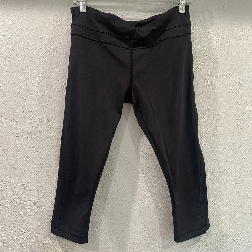 LuLuLemon black capris women's size 8 with side mesh accent at hem. EUC